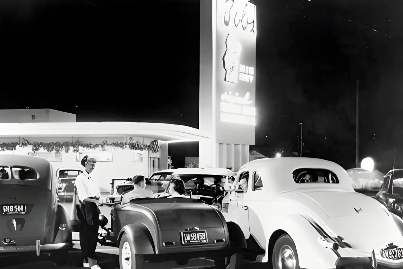 The Bob's Big Boy drive-in at night, lined with classic cars.